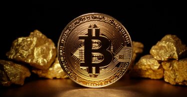 Gold Nuggets with a Bitcoin Coin surrounding it