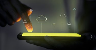 Finger with touch screen phone with cloud and wifi images overlaid on top