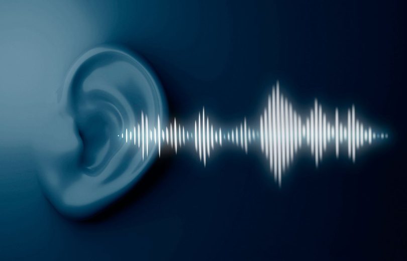 White Sound waves coming from light blue ear with dark blue back ground. Image Source: Freepik
