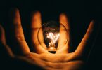 Lightbulb in a hand with darkness background | Photo by Rohan Makhecha on Unsplash