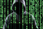 One of those Hackers in a black hoodie with green matrix like text and graphics overlaid on top