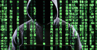 One of those Hackers in a black hoodie with green matrix like text and graphics overlaid on top