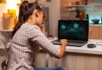 Angry hacker woman because of access denied while trying to attack government firewall. Programmer writing a dangerous malware for cyber attacks using performance laptop during midnight.