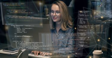 Picture of white woman with glasses coding with heads up display of FOSS code user interface overlaid